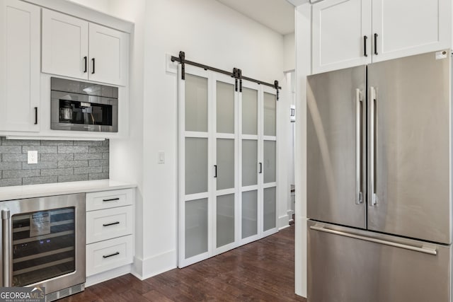 kitchen with stainless steel refrigerator, wine cooler, and white cabinetry