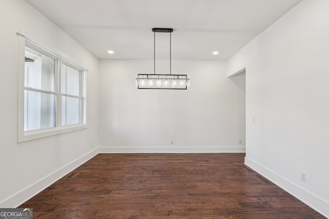 unfurnished dining area featuring dark wood-type flooring