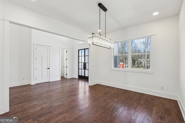 unfurnished dining area featuring dark wood-type flooring and a healthy amount of sunlight