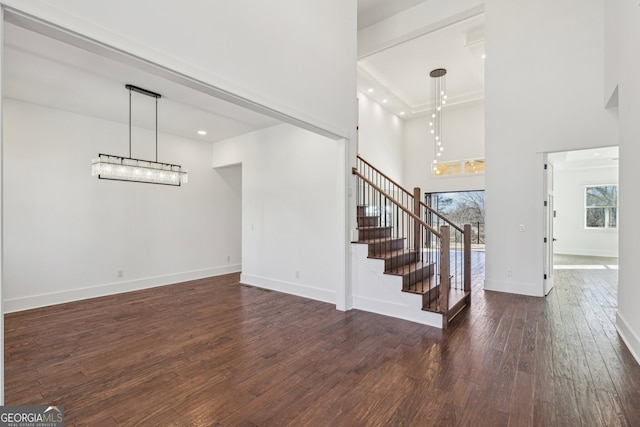 interior space featuring a high ceiling, hardwood / wood-style floors, and plenty of natural light