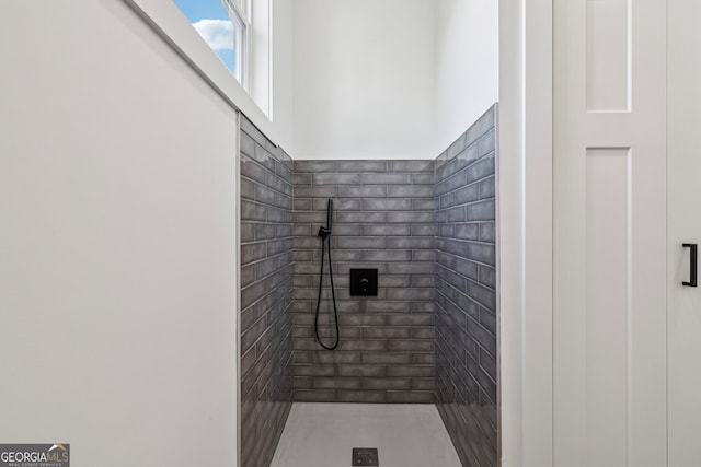 bathroom with tiled shower