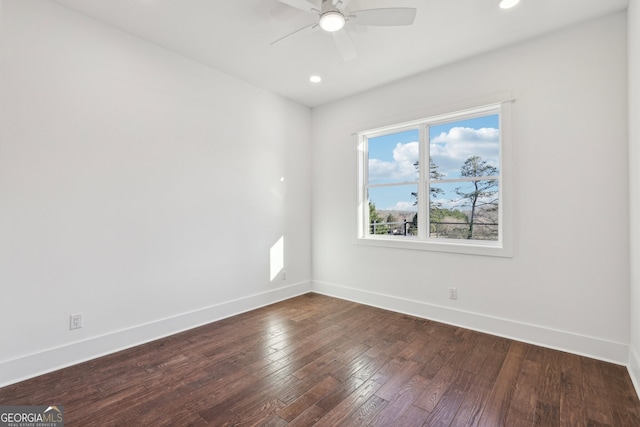 empty room with ceiling fan and dark hardwood / wood-style floors