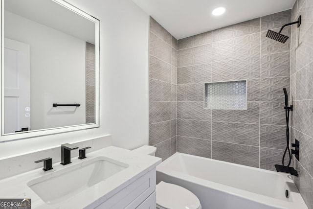 full bathroom with toilet, vanity, and tiled shower / bath combo