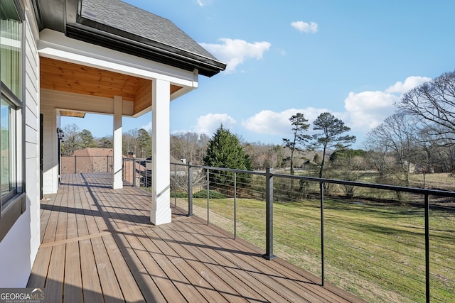 wooden terrace with a lawn