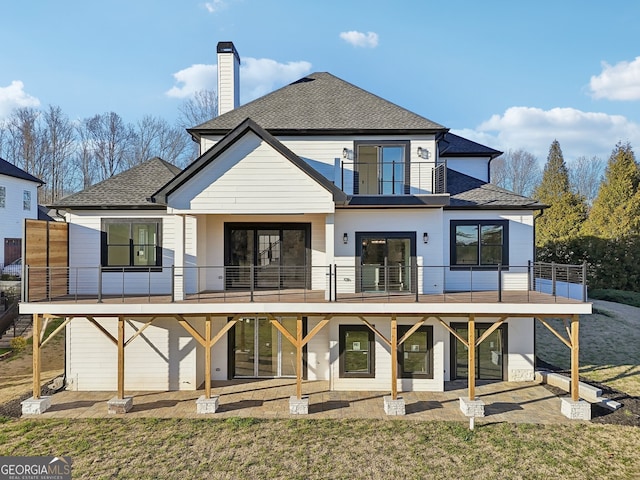 rear view of property with a lawn and a patio area