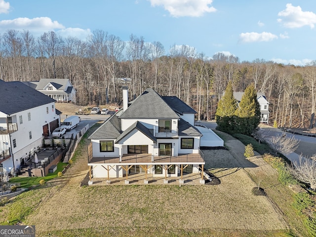 rear view of house with a garage and a yard