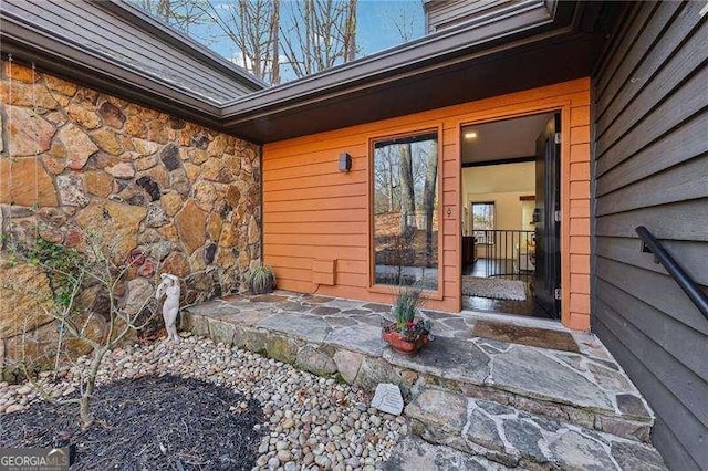 doorway to property with stone siding