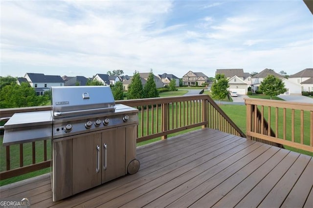 wooden terrace featuring a residential view and a lawn