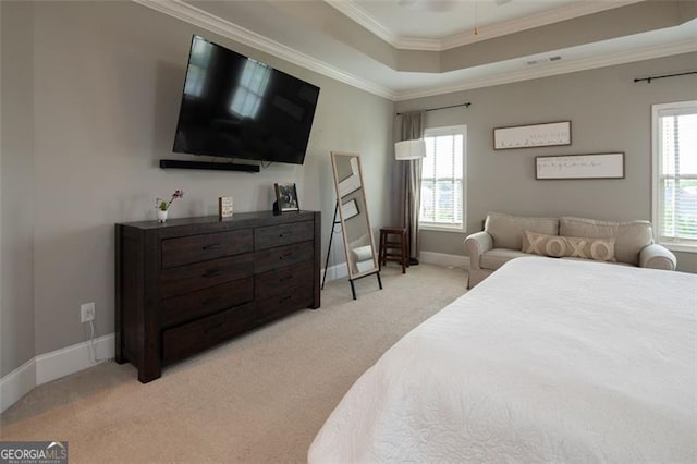 bedroom featuring baseboards, a tray ceiling, crown molding, and light colored carpet