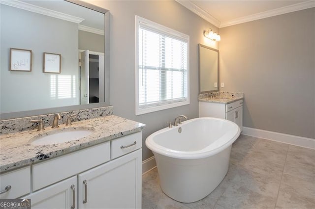 full bath with a freestanding tub, crown molding, two vanities, and a sink