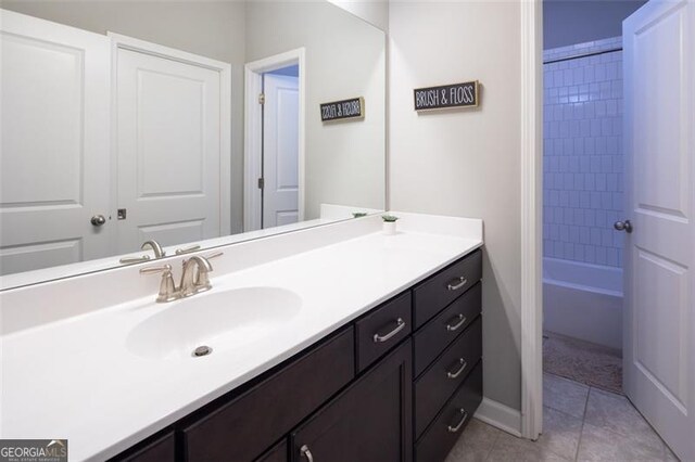 bathroom with shower / bathtub combination, vanity, baseboards, and tile patterned floors