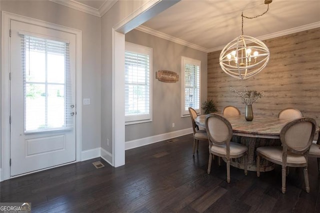 dining area with a chandelier, ornamental molding, dark wood-style flooring, and baseboards