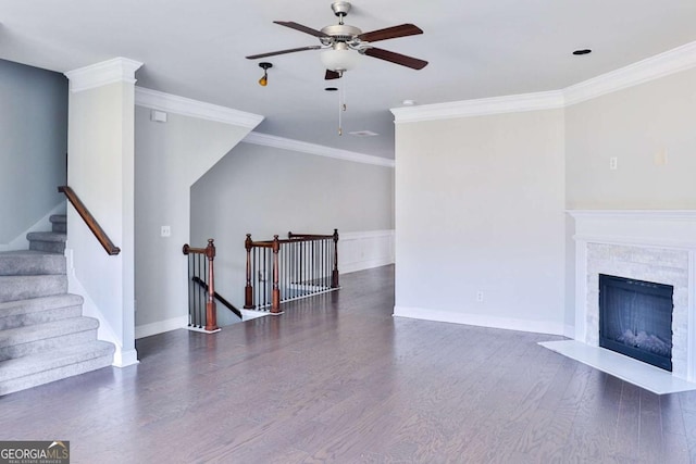 living area with ornamental molding, a fireplace, dark wood finished floors, and ceiling fan