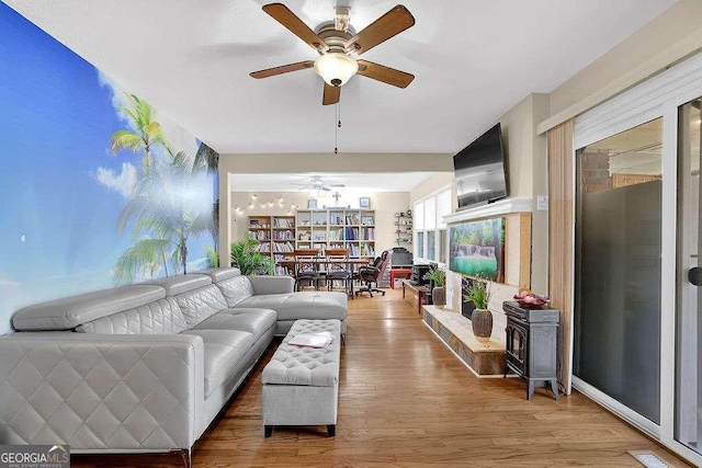 living room featuring ceiling fan and wood-type flooring