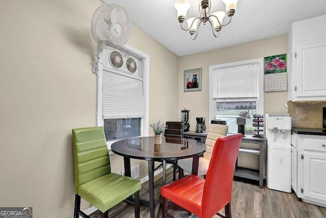 dining room featuring hardwood / wood-style flooring and a notable chandelier