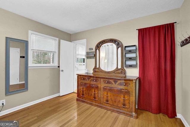 interior space with light hardwood / wood-style floors and a textured ceiling