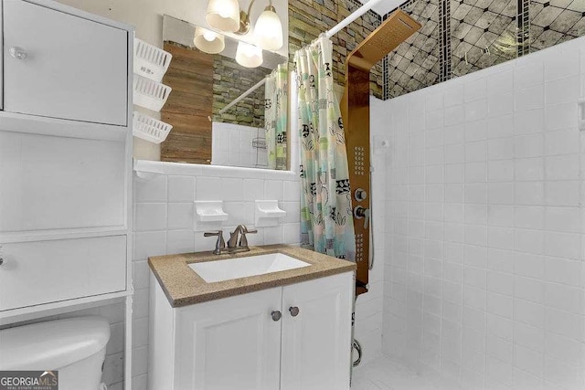 bathroom with curtained shower, toilet, tile walls, tasteful backsplash, and vanity