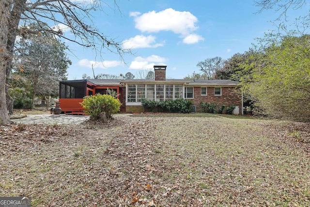 back of house featuring a patio area and a sunroom