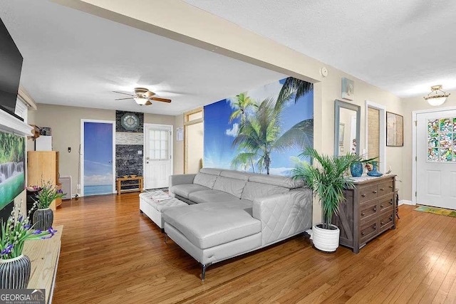 living room featuring ceiling fan and hardwood / wood-style floors