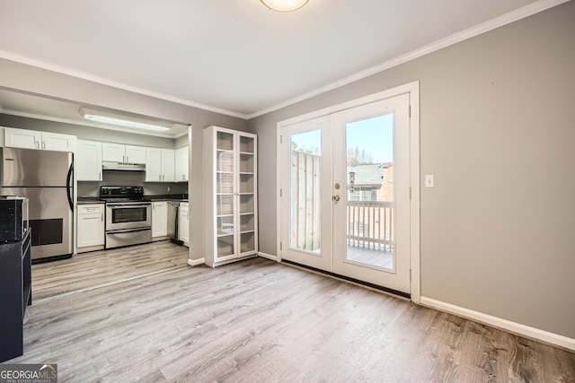 kitchen featuring french doors, stainless steel appliances, dark countertops, white cabinets, and under cabinet range hood