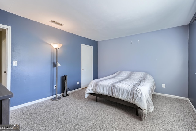 carpeted bedroom featuring visible vents and baseboards