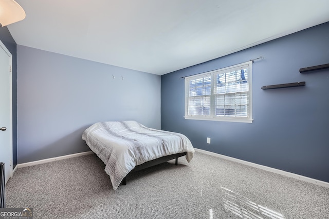 bedroom featuring carpet and baseboards