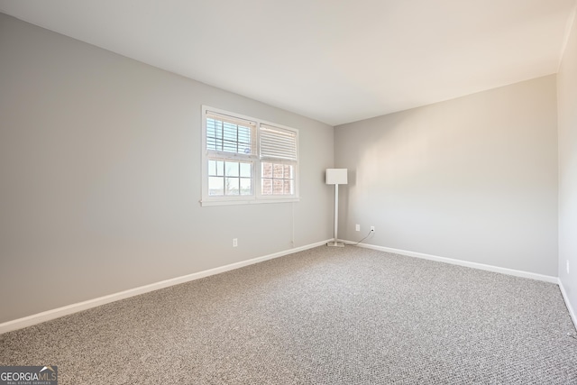 carpeted empty room with baseboards