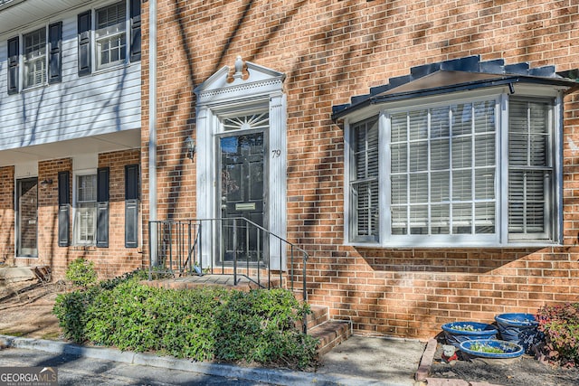 doorway to property with brick siding