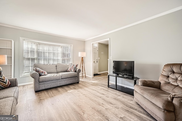 living room featuring ornamental molding, light wood-style flooring, and baseboards