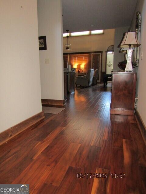 hallway with dark hardwood / wood-style flooring