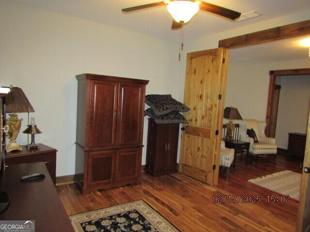 office area featuring ceiling fan and dark wood-type flooring