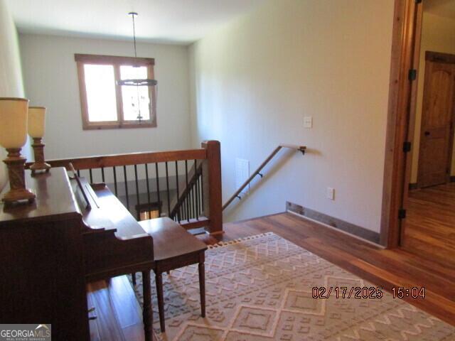 stairway with hardwood / wood-style flooring