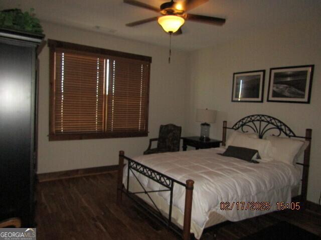 bedroom featuring ceiling fan and dark hardwood / wood-style flooring