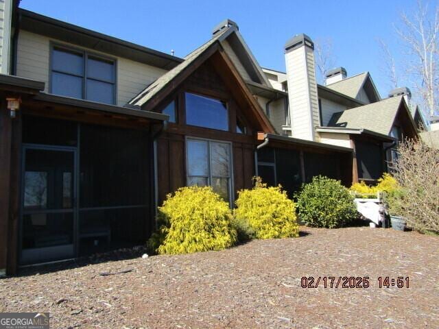 rear view of house with a sunroom