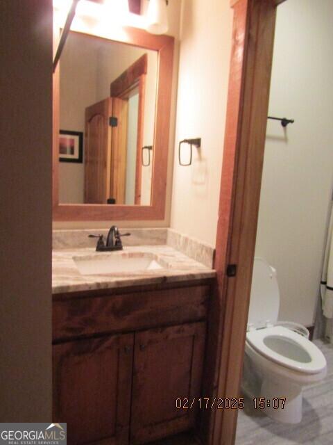 bathroom with vanity and toilet