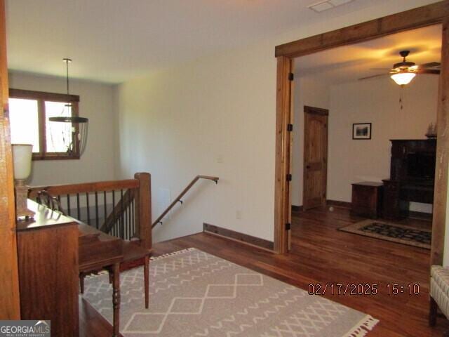 staircase featuring ceiling fan and wood-type flooring