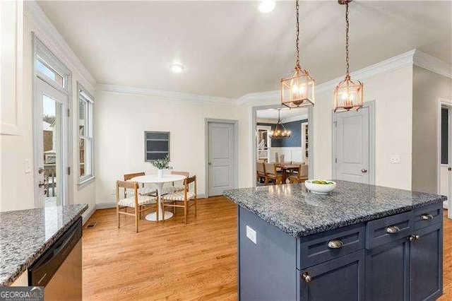 kitchen with a center island, light wood-type flooring, dark stone counters, decorative light fixtures, and stainless steel dishwasher