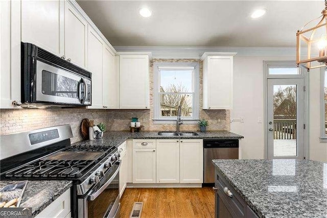 kitchen featuring white cabinetry, appliances with stainless steel finishes, and sink