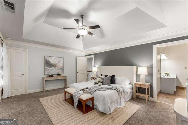 bedroom with a tray ceiling, crown molding, light colored carpet, and ceiling fan