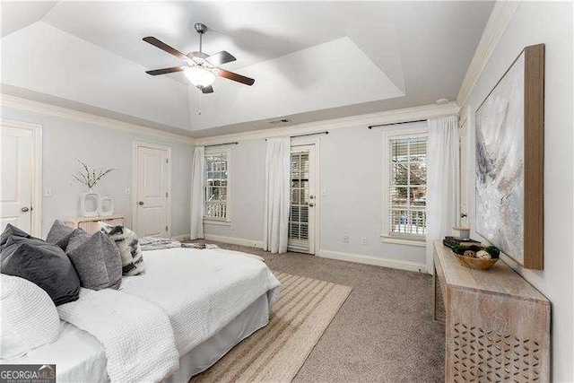 bedroom with ceiling fan, a raised ceiling, light carpet, access to exterior, and ornamental molding