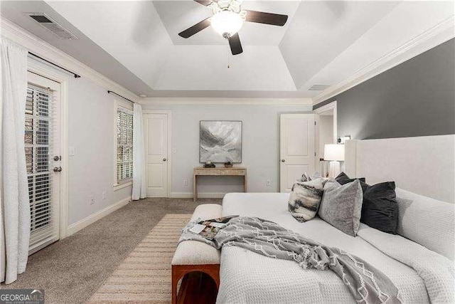 carpeted bedroom with a tray ceiling, crown molding, access to outside, and ceiling fan