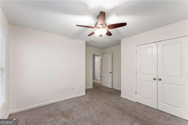 unfurnished bedroom with ceiling fan, a closet, and light colored carpet