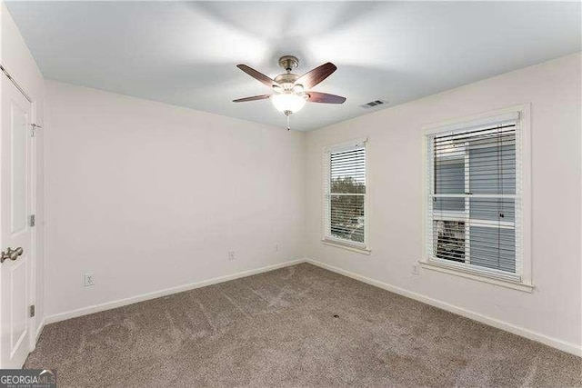 carpeted empty room featuring ceiling fan