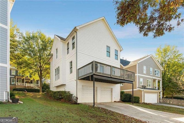 exterior space with a yard, a wooden deck, and a garage