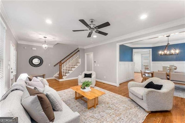 living room with light wood-type flooring and crown molding