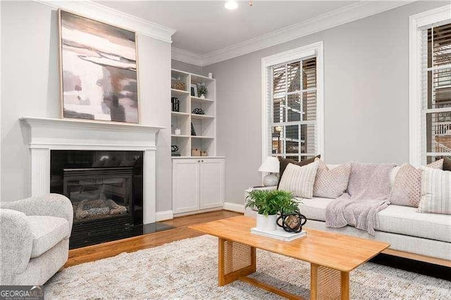 living room with hardwood / wood-style flooring and ornamental molding