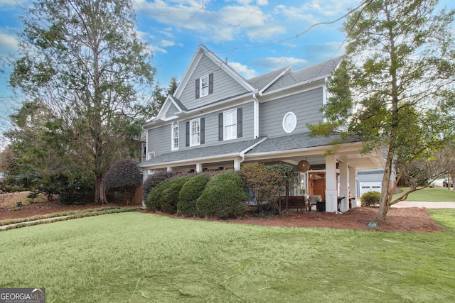 view of front of home with a front yard and a garage