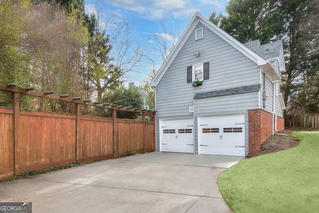 view of home's exterior featuring a garage and a lawn