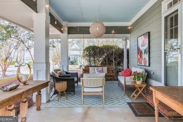 sunroom / solarium with decorative columns and a healthy amount of sunlight