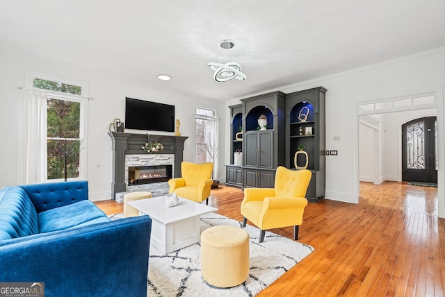 living room featuring light wood-type flooring and ornamental molding